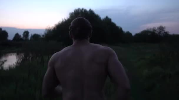 Joven chico en forma corriendo al atardecer — Vídeos de Stock