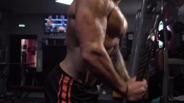 Spor kablosu makinesinde çalışan formda bir adam.