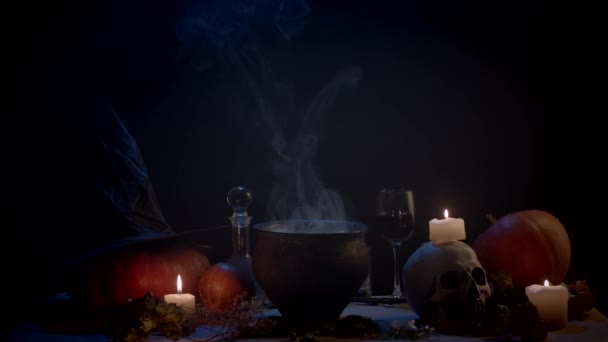 Steaming Cauldron Candles Pumpkins Table Dark — Stock Video