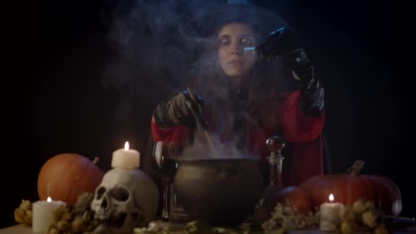 Young Witch Adding Something Sparkly Cauldron — Stock Video
