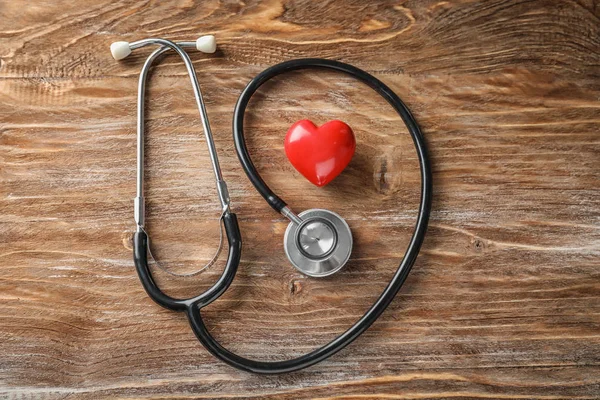 Estetoscopio Con Corazón Rojo Sobre Fondo Madera Concepto Salud —  Fotos de Stock