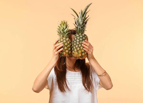 Junge Frau Versteckt Gesicht Hinter Zwei Ananas Auf Farbigem Hintergrund — Stockfoto