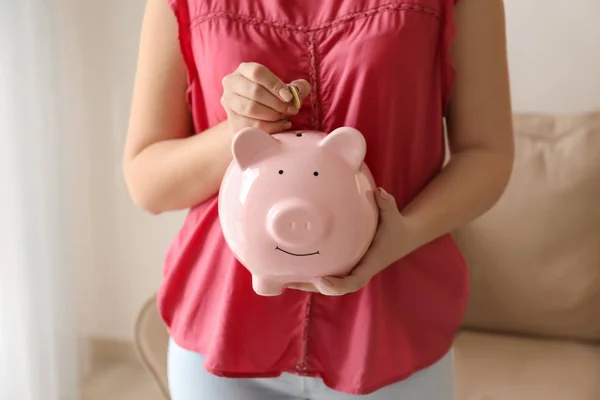 Woman Putting Coin Piggy Bank Indoors Money Savings Concept — Stock Photo, Image