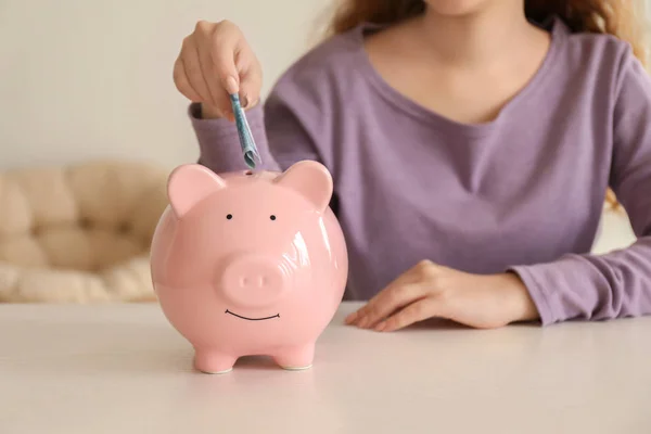 Young Woman Putting Euro Banknote Piggy Bank Indoors Money Savings — Stock Photo, Image