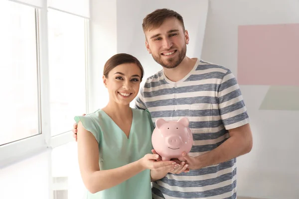 Happy Couple Holding Piggy Bank Indoors Money Savings Concept — Stock Photo, Image