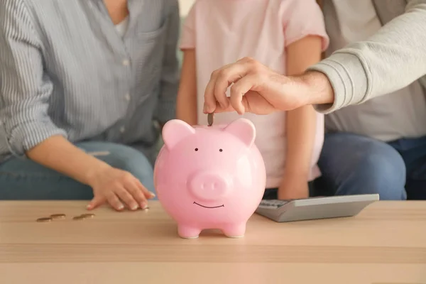 Little Girl Her Parents Putting Coins Piggy Bank Indoors Money — Stock Photo, Image