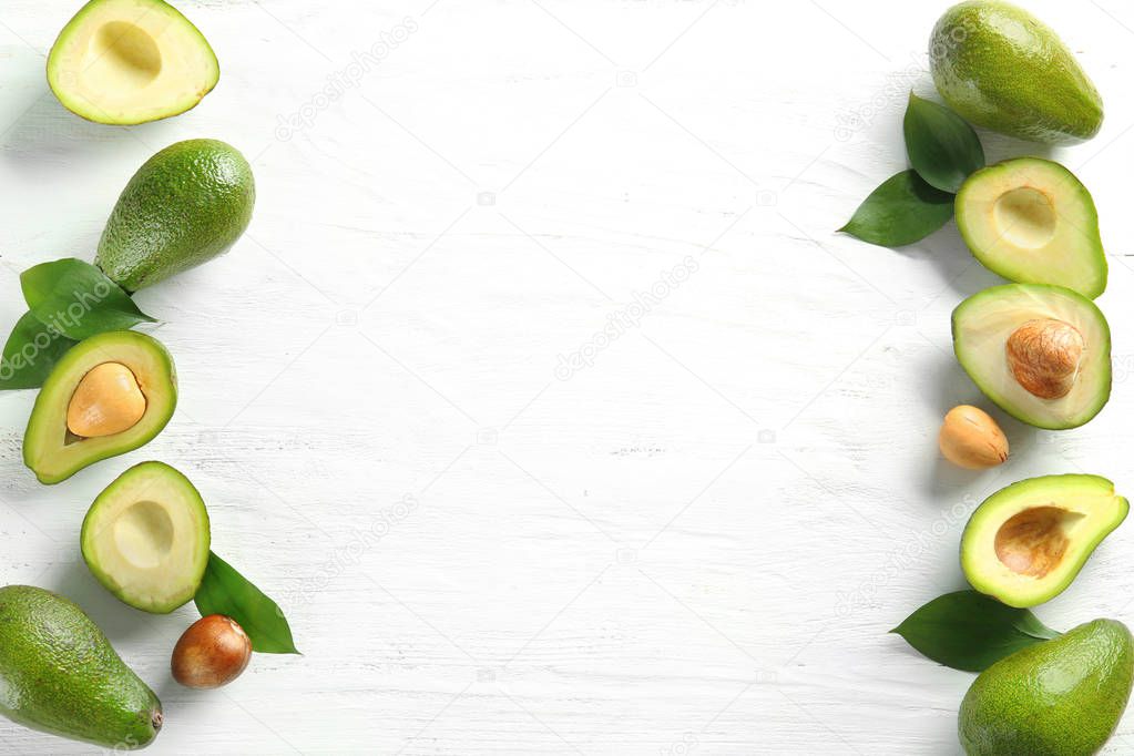 Composition with ripe avocados on white background