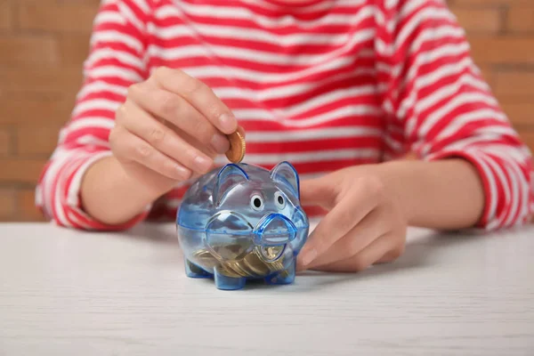 Woman Putting Coin Piggy Bank Table — Stock Photo, Image