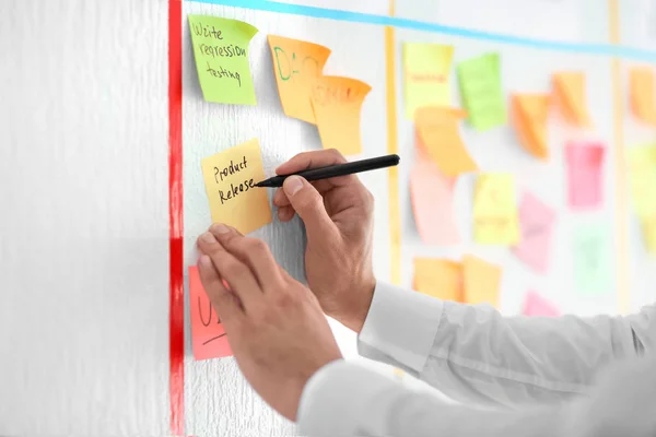 Man Writing Sticky Note Attached Scrum Task Board Office — Stock Photo, Image