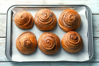 Fırın tepsisi masada tatlı tarçınlı çörek ile