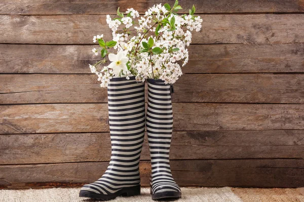 Rubber Boots Blossoming Branches Wooden Wall — Stock Photo, Image