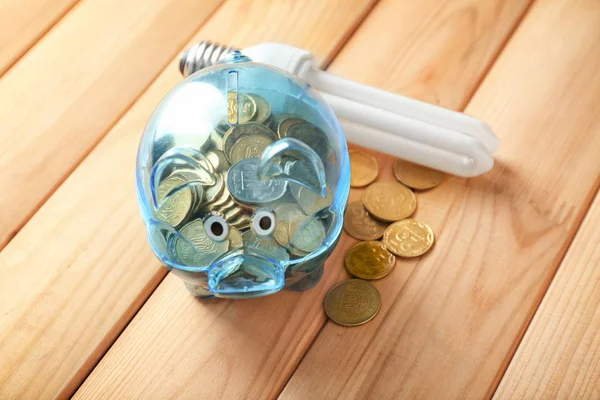 Piggy Bank Coins Light Bulb Wooden Background Electricity Saving Concept — Stock Photo, Image