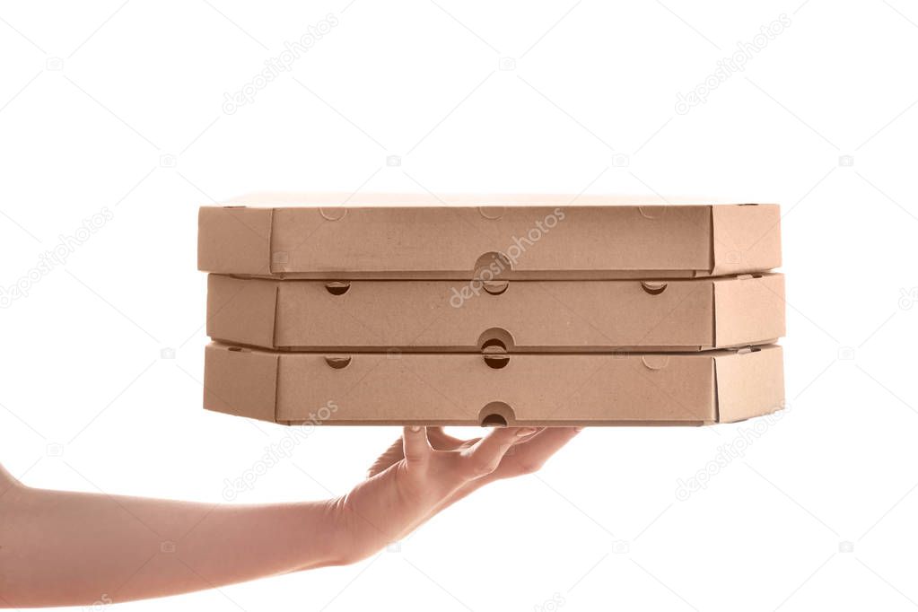 Hand of delivery woman with cardboard pizza boxes on white background