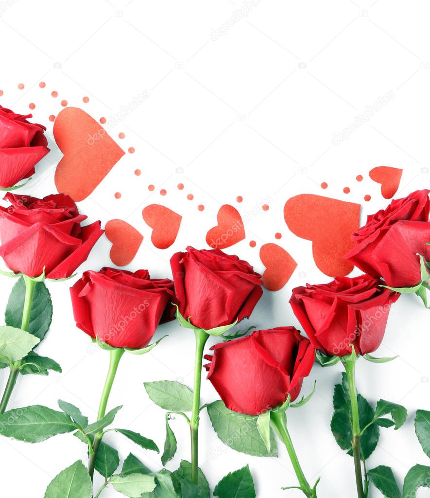Beautiful roses and paper hearts on white background