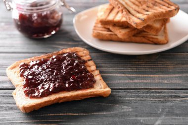 Ahşap masa üzerinde reçelli ekmek