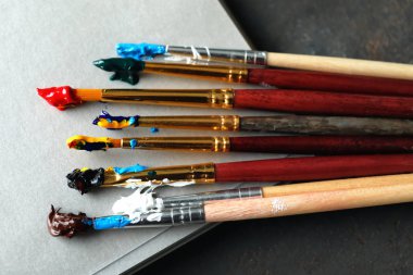 Boya fırçaları masada, closeup ile defter