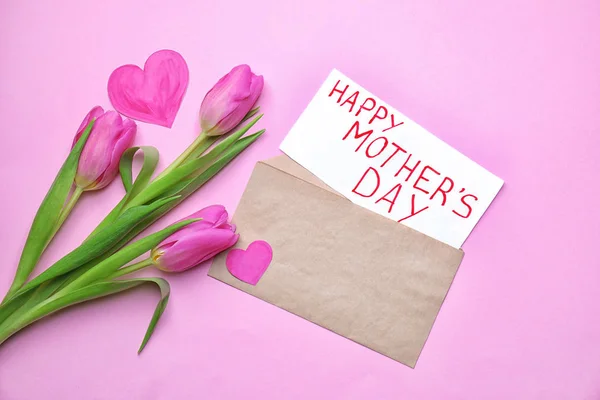 美丽的郁金香和卡片以文本愉快的母亲节在颜色背景 — 图库照片