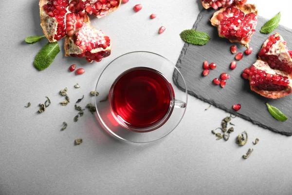 Flat Lay Composition Glass Cup Red Tea Pomegranate Grey Background — Stock Photo, Image