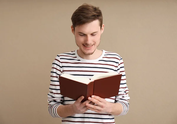 Young Man Reading Book Color Background — Stock Photo, Image