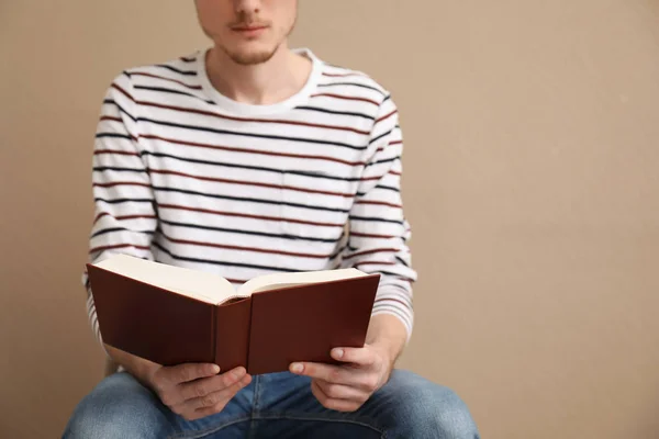 Junger Mann Liest Buch Auf Farbigem Hintergrund — Stockfoto