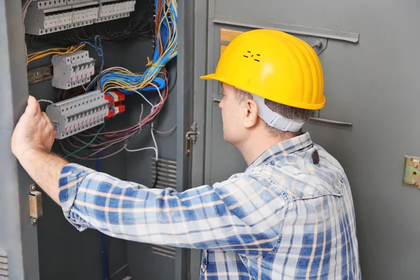 Mature Electrician Repairing Distribution Board Indoors — Stock Photo, Image