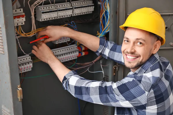 Electrician repairing distribution board