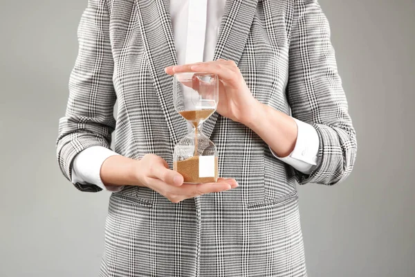 Woman Holding Hourglass Grey Background Time Management Concept — Stock Photo, Image