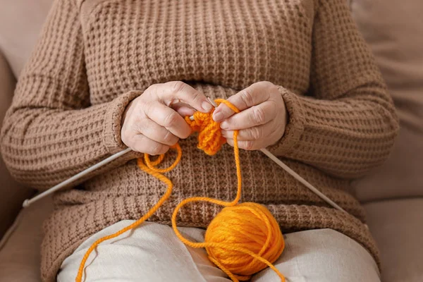 Senior Kobieta Siedzi Kanapie Podczas Knitting Sweter Domu — Zdjęcie stockowe