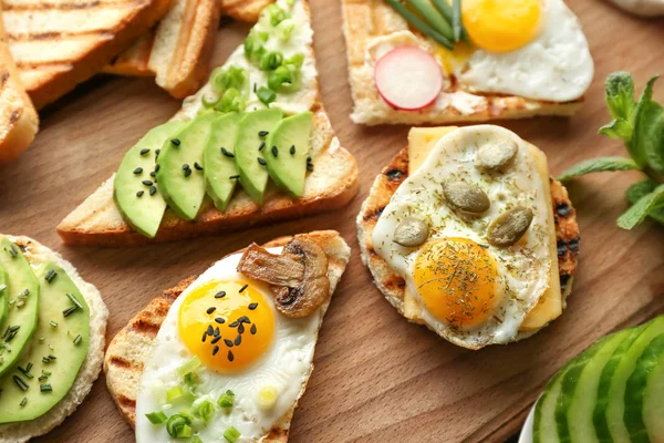 Different Delicious Toasts Wooden Board — Stock Photo, Image