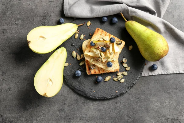 Tasty Sweet Toasts Sliced Pear Blueberry Seeds Slate Plate — Stock Photo, Image