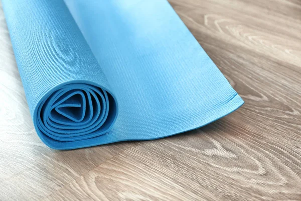 Yoga mat on wooden floor