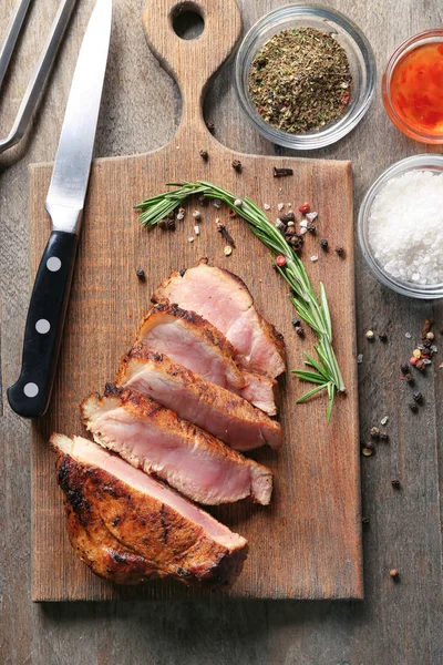 Ahşap tahta üzerinde lezzetli biftek dilimlenmiş