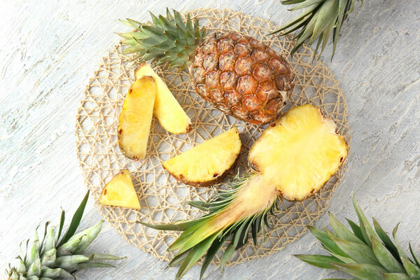 Composition with delicious pineapples on wooden background