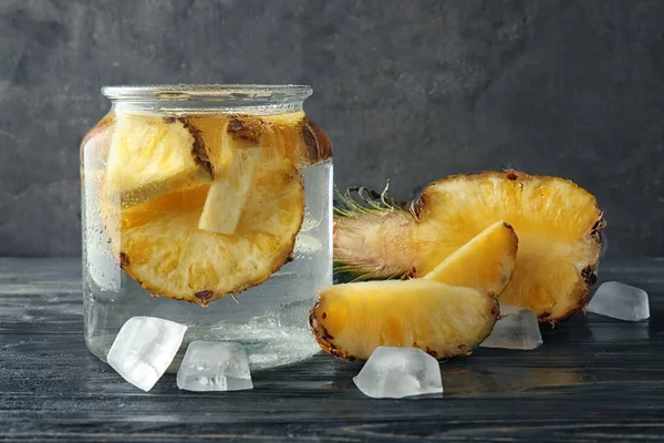 Glass Jar Slices Delicious Pineapple Ice Cubes Wooden Table — Stock Photo, Image