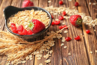 Bir kase yulaf ezmesi gevreği ve çilek ahşap tablo