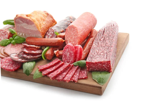 Assortment of delicious deli meats on wooden board, isolated on white