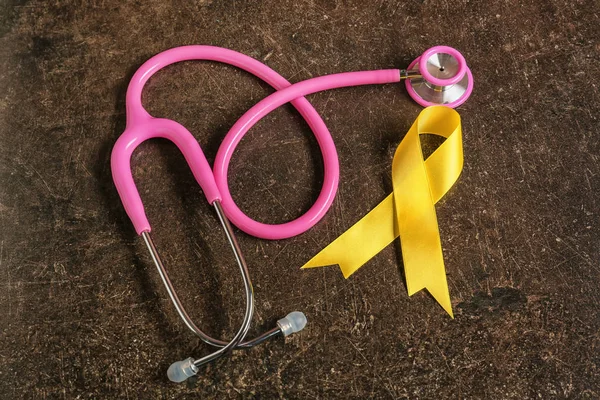 Yellow Ribbon Stethoscope Dark Background Cancer Concept — Stock Photo, Image