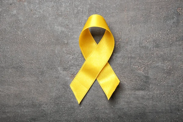 Yellow Ribbon On Light Background. Cancer Concept Stock Photo, Picture and  Royalty Free Image. Image 116011692.