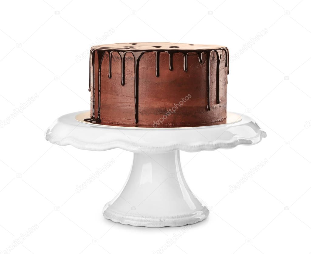 Stand with delicious chocolate cake on white background