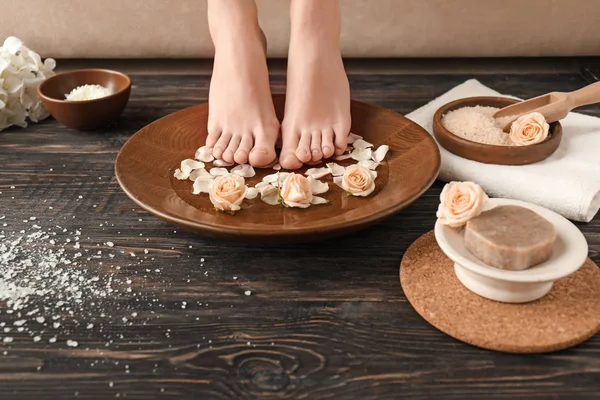 Young woman undergoing spa pedicure treatment in beauty salon