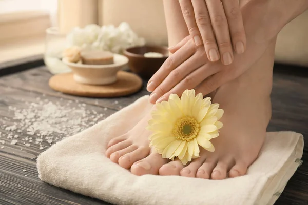 Young woman with beautiful pedicure and manicure after treatment in spa salon, closeup