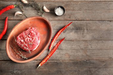 Taze çiğ et, baharatlar ve sebzeler ahşap arka plan üzerinde düz yatıyordu kompozisyon