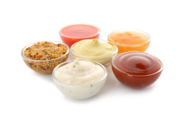 Bowls with different sauces on white background clipart