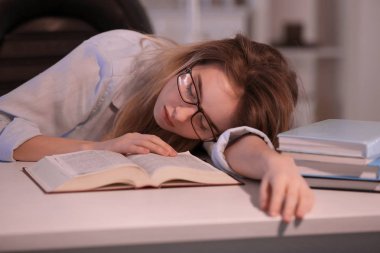 Akşam masada yatıyor kitapla genç kadın