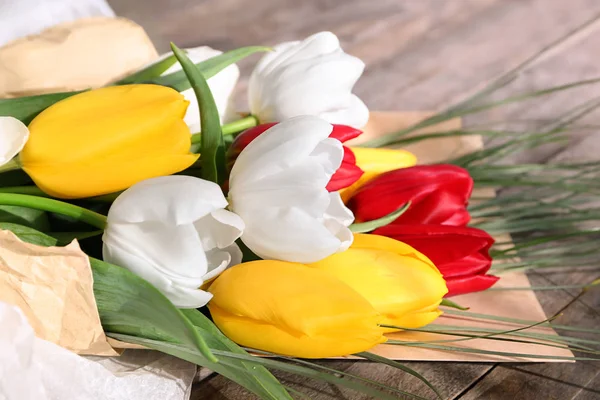 Beautiful flowers as gift on table, closeup