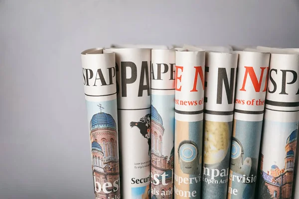 Rolled Newspapers Grey Background — Stock Photo, Image