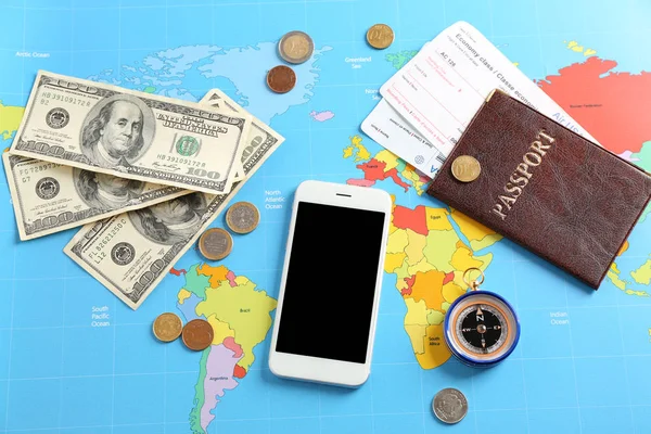 携帯電話 パスポート 世界地図上のお金 旅行の概念 — ストック写真