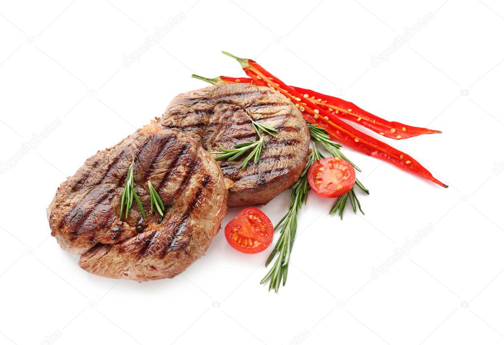 Delicious grilled meat with rosemary and vegetables on white background