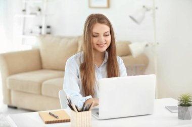 Ev ofis içinde laptop üzerinde çalışan kadın serbest meslek