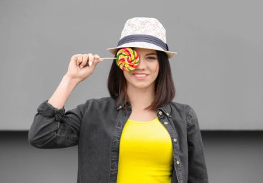 Lolipop gri arka plan üzerinde olan güzel kadın